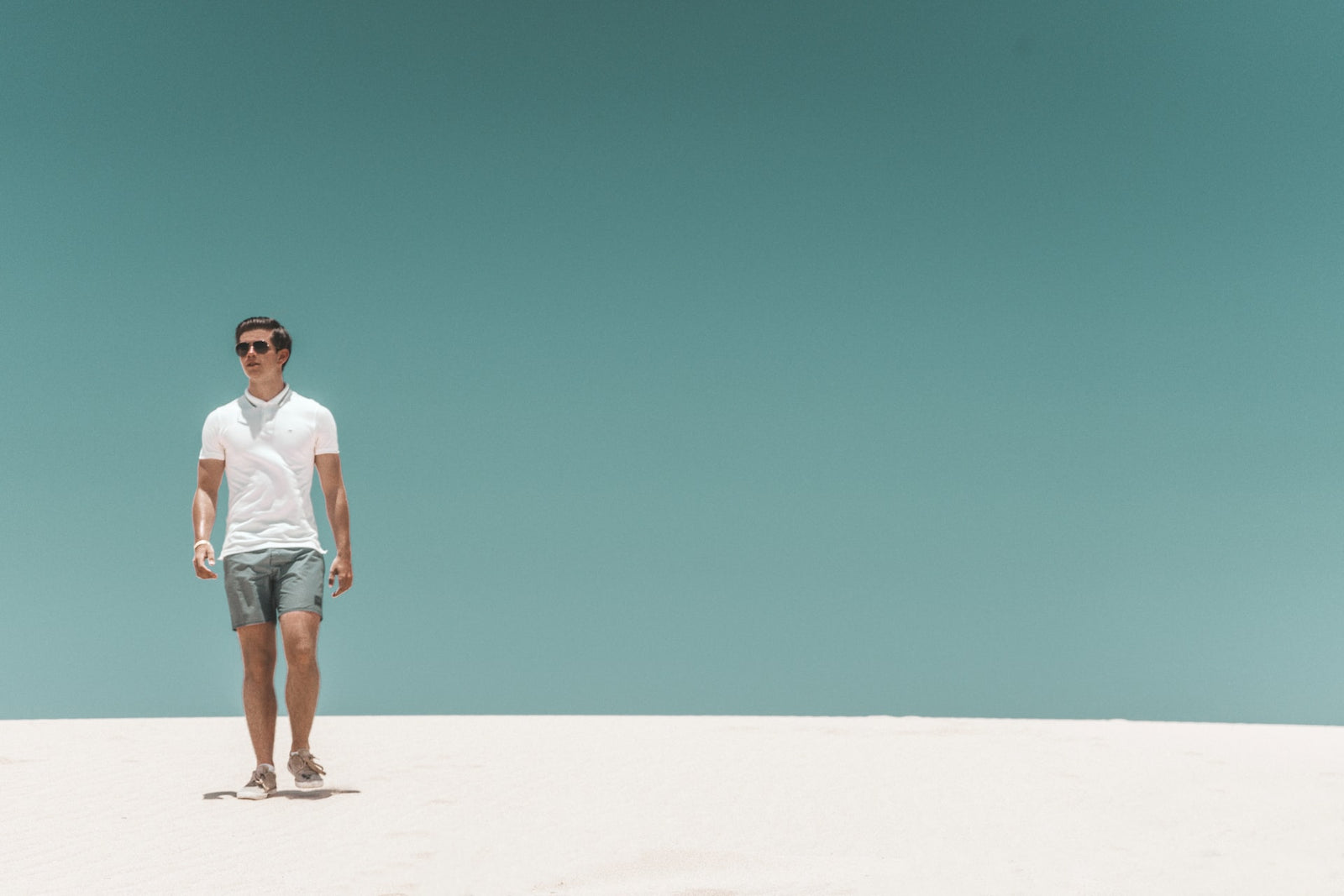 man wearing polo shirt at the beach