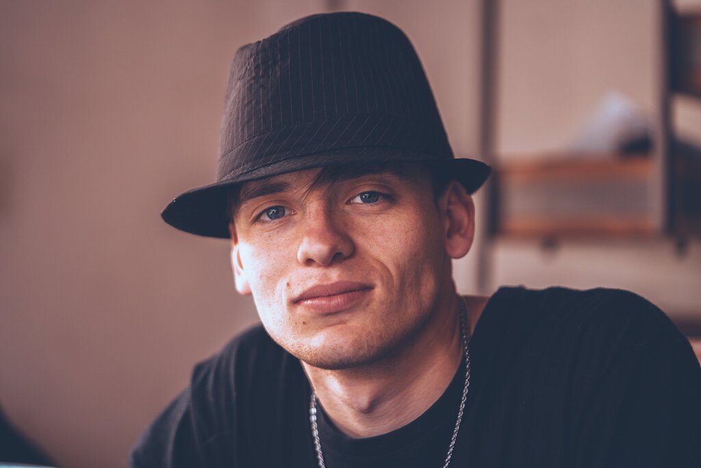 man wearing a brimless hat